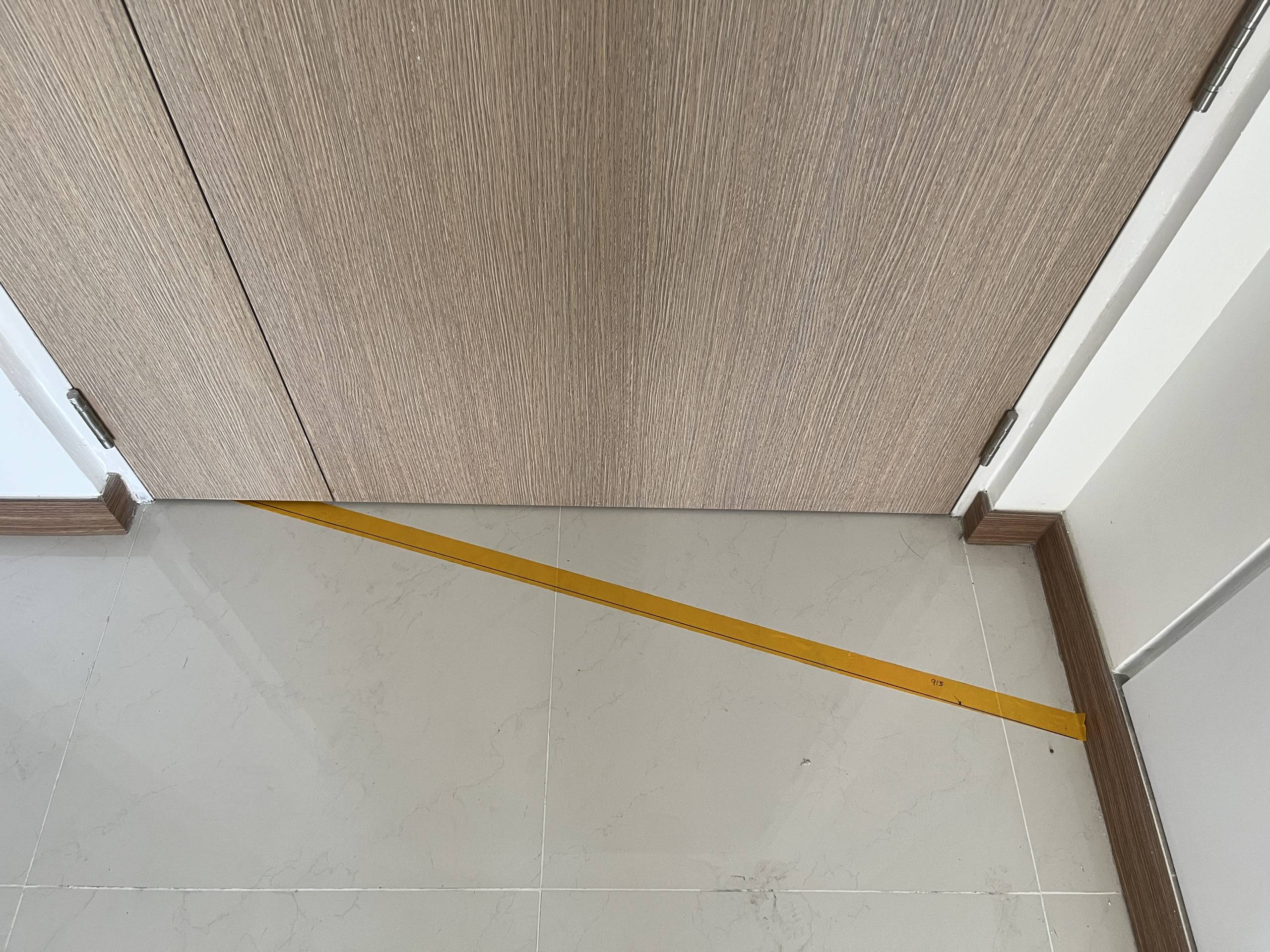 Aluminium transition trim between kitchen tile and living floor